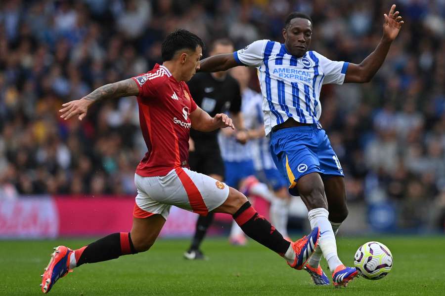 Manchester United defender Lisandro Martinez vies with Brighton striker Danny Welbeck