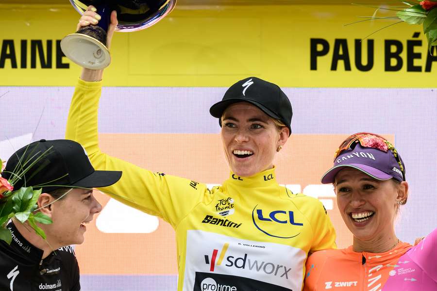 First-placed Team SD Worx's Dutch rider Demi Vollering (C) wearing the overall leader's yellow jersey First-placed Team SD Worx's Dutch rider Demi Vollering (C) wearing the overall leader's yellow jersey