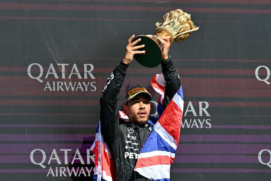 Lewis Hamilton lifts the trophy after winning the race