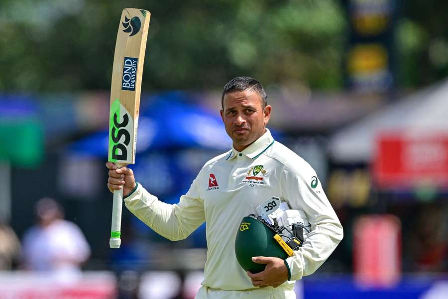 Usman Khawaja raises his bat after being dismissed for 232