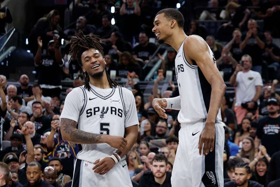 Stephon Castle (left) and Victor Wembanyama of the San Antonio Spurs react