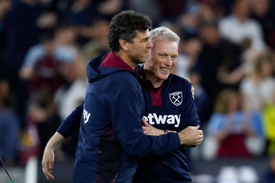 West Ham United's Scottish manager David Moyes (R) celebrates with a staff member at the end of the English Premier League football match between West Ham United and Manchester United