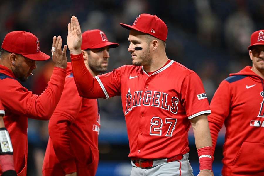 Los Angeles Angels star Mike Trout high-fives teammates and coaches following the win over the Cleveland Guardians (May 30, 2025)