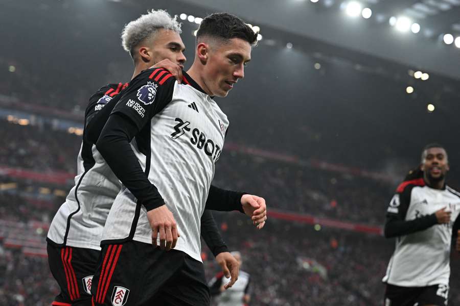 Fulham's Welsh midfielder #08 Harry Wilson (2L) celebrates with Fulham's English-born US defender #33 Antonee Robinson (L) after scoring their first goal