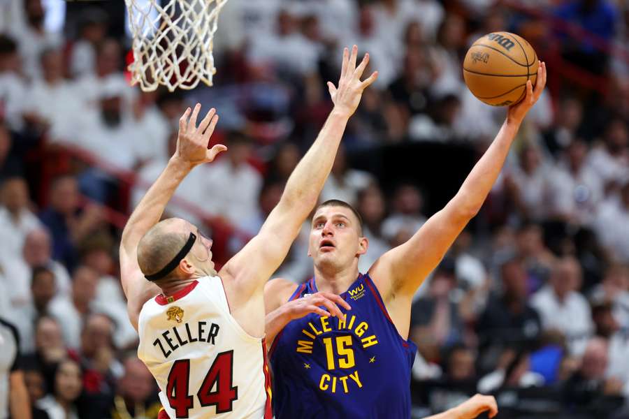 Nikola Jokic of the Denver Nuggets drives to the basket against Cody Zeller of the Miami Heat