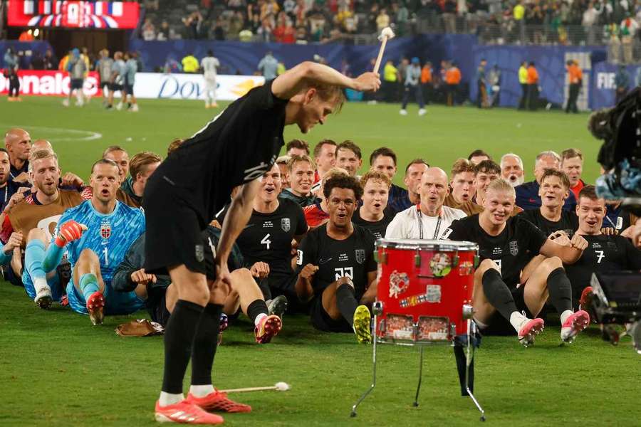 Norway's Martin Odegaard beats a drum as players and coaches perform the 'Viking Row' after defeating Senegal 3-2