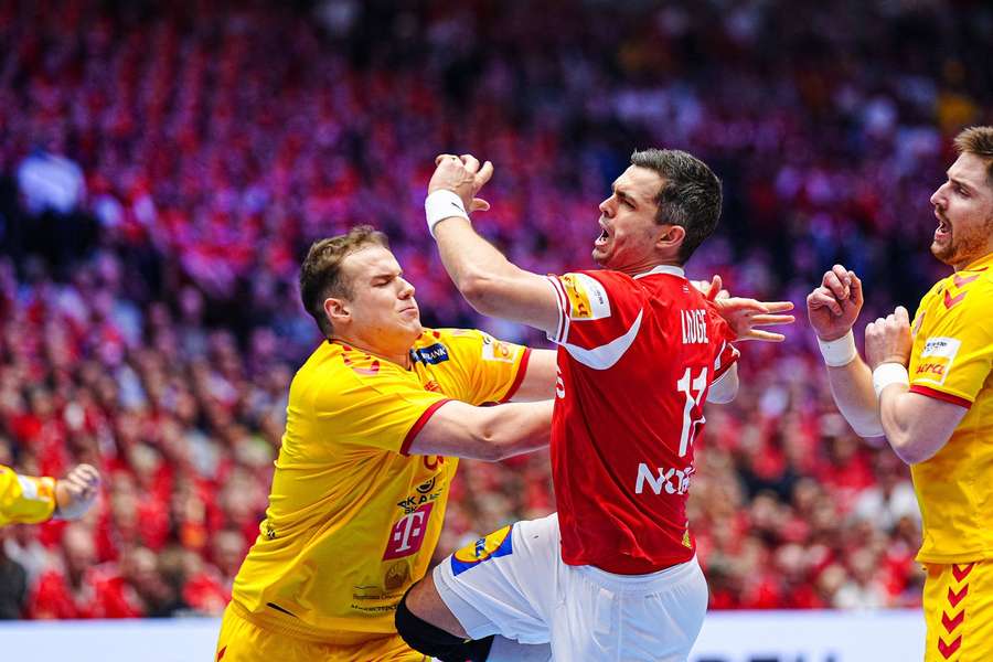 North Macedonia's Samoil Ristevski tries to tackle Rasmus Lauge during the match in Herning