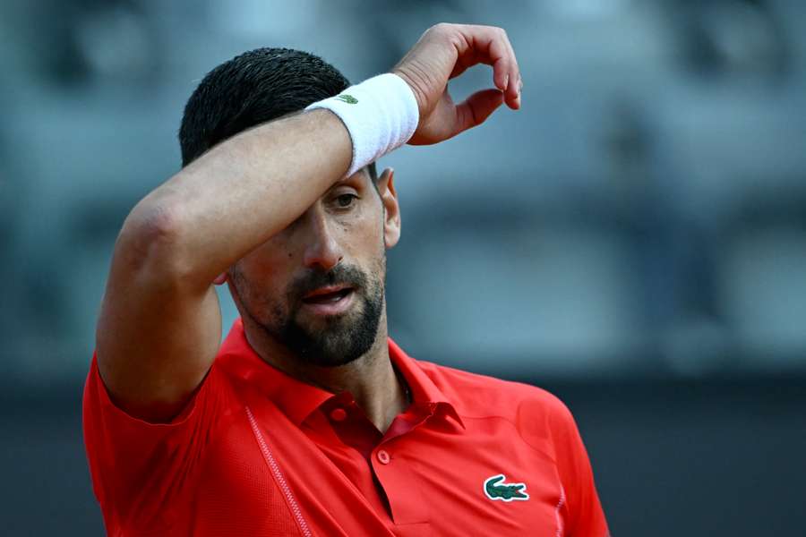 Djokovic sank to the ground after a bottle was thrown at his head
