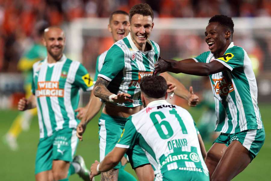 Rapid Wien celebrate beating Dundee United in UEFA Conference League qualifying on penalties.