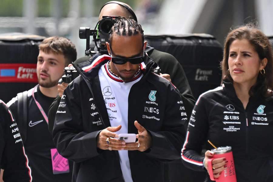 Mercedes' British driver Lewis Hamilton walks in the paddock ahead of the Formula 1 British Grand Prix at Silverstone