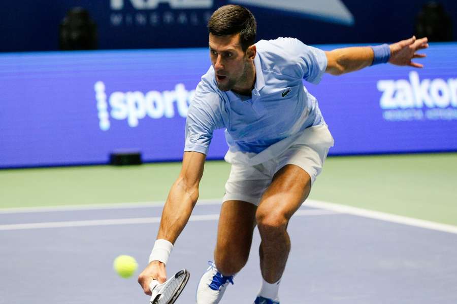 Djokovic returns the ball against Medvedev