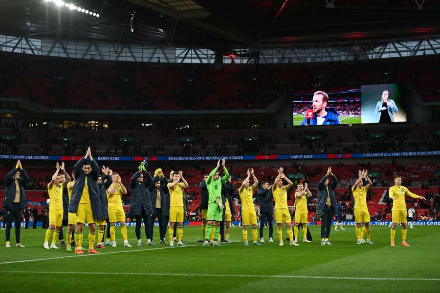 Ukraine players applauds the fans following the match