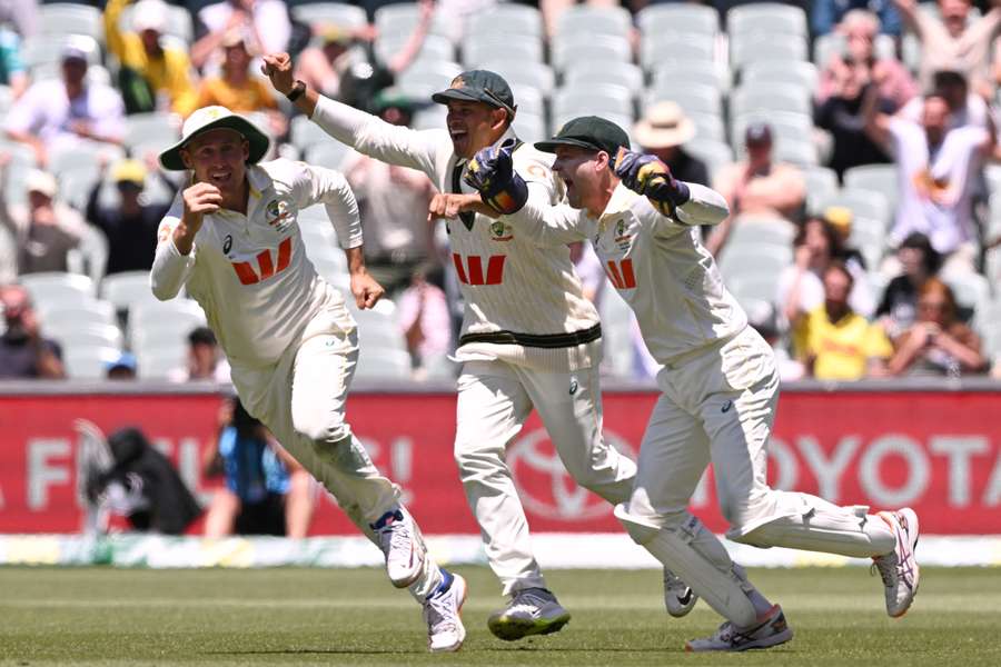 Australia's Marnus Labuschagne (L), Usman Khawaja (C) and Alex Carey (R) celebrate after Labuschagne caught Josh Tongue to seal the Ashes