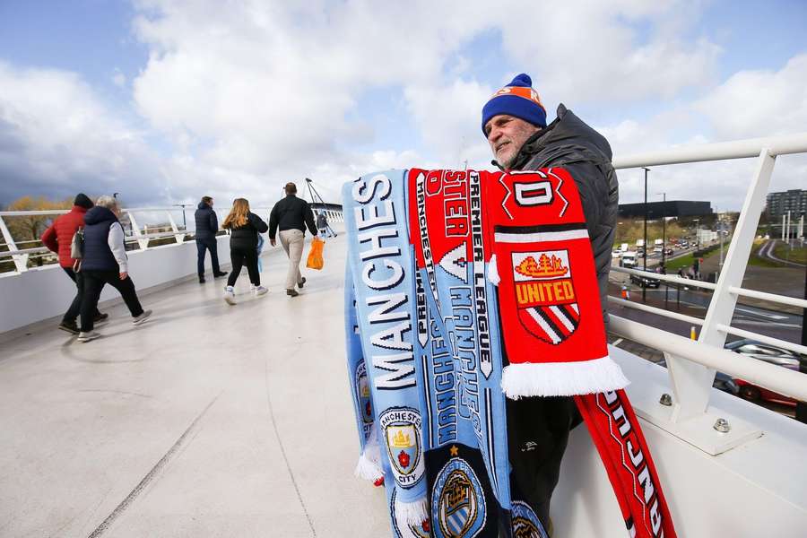 A street vendor selling half and half scarves ahead of the Manchester derby.