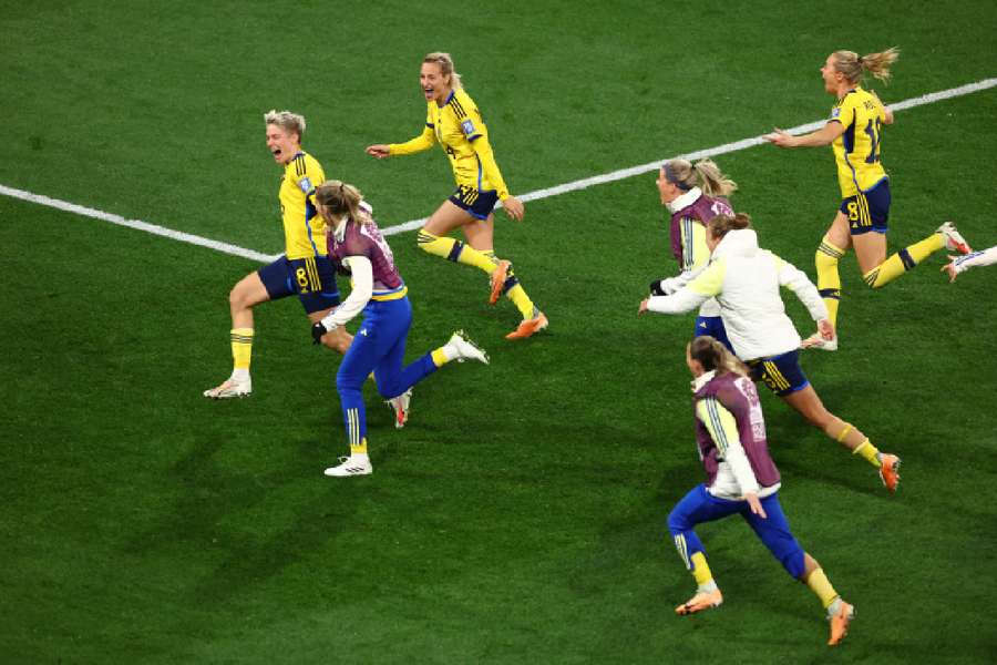 Sweden's Lina Hurtig celebrates with teammates after scoring the winning penalty