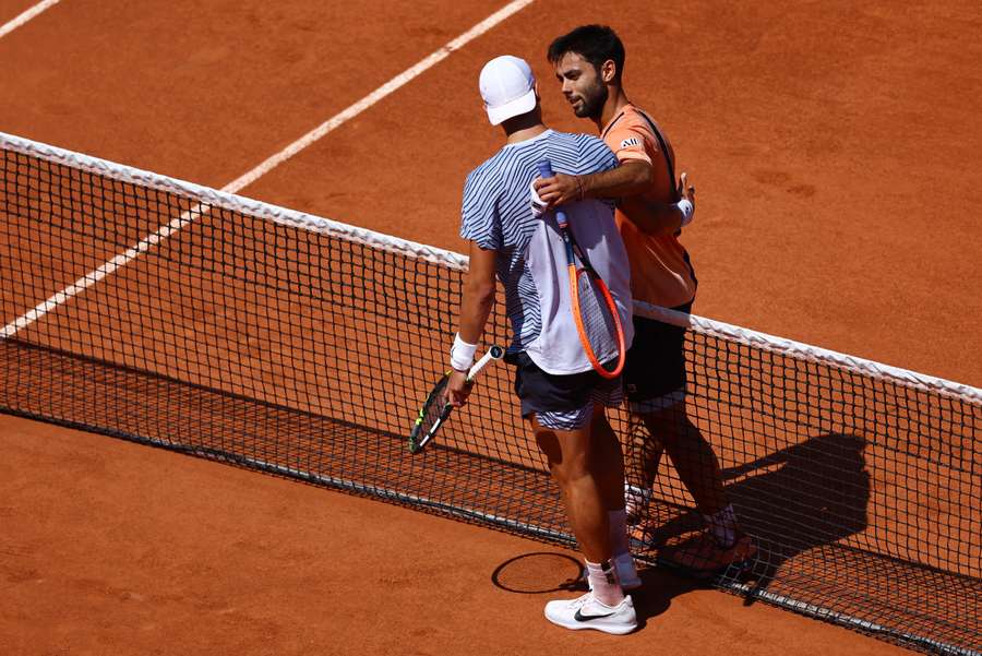 Rune and Olivieri meet at the net after the match