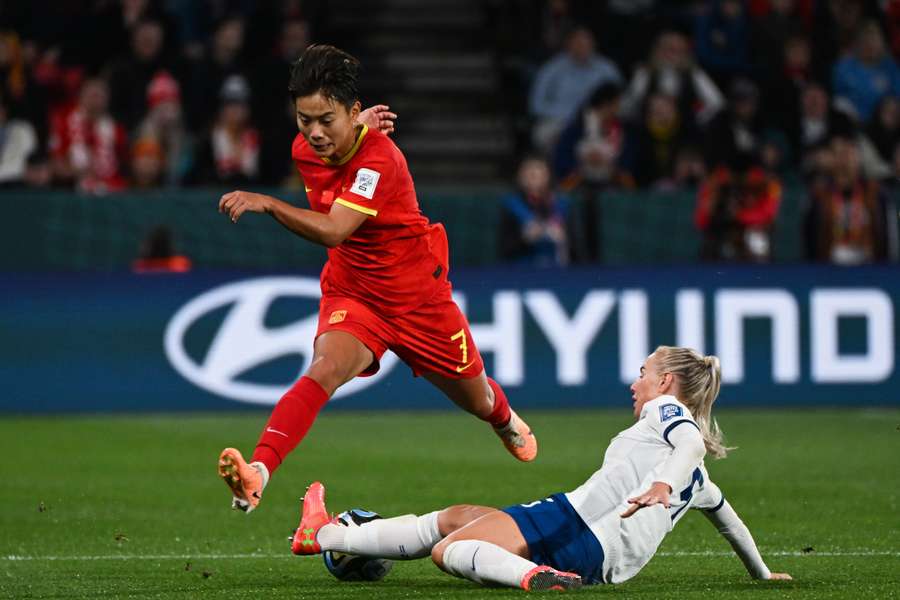 China's Wang (L) is tackled by Alex Greenwood