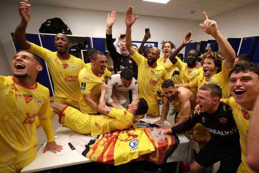 Le Mans' players and staff celebrate after their match against Bastia