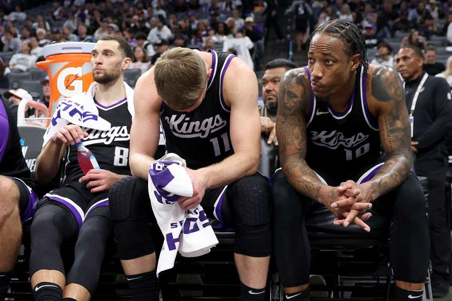 Kings players Zach LaVine (left), Domantas Sabonis (middle), and DeMar DeRozan (right) react during their loss to the Dallas Mavericks