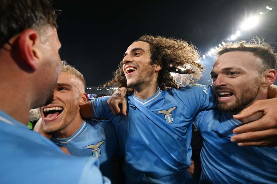 Lazio's Matteo Guendouzi celebrates with teammates after the match