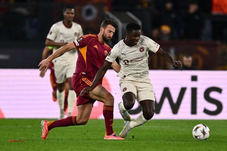 Franculino battling with AS Roma's Bryan Cristante in a Europa League match
