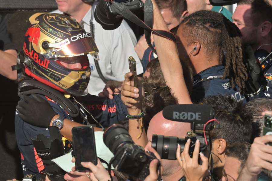 Max Verstappen celebrates with teammates after winning the Formula 1 Brazil Grand Prix