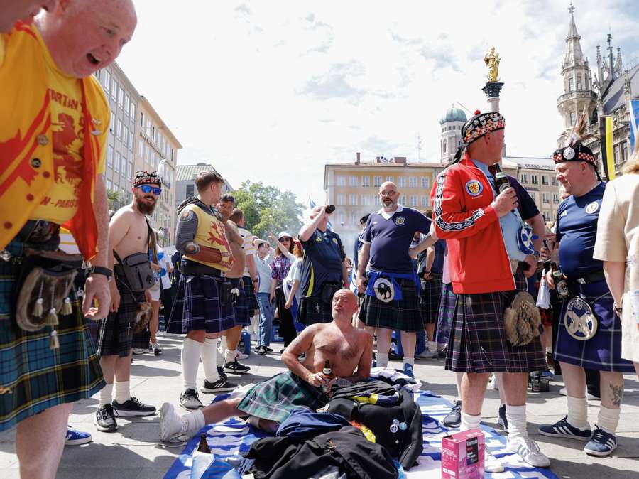 Supporters of Scotland's national soccer team celebrate with beer crates at the central square Marienplatz