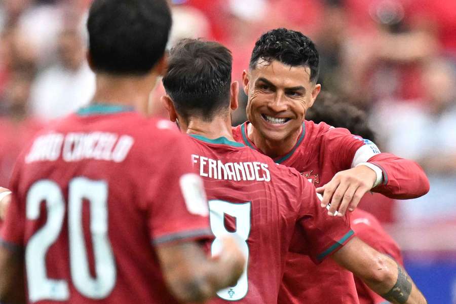 Cristiano Ronaldo celebrates scoring Portugal's third goal with Bruno Fernandes