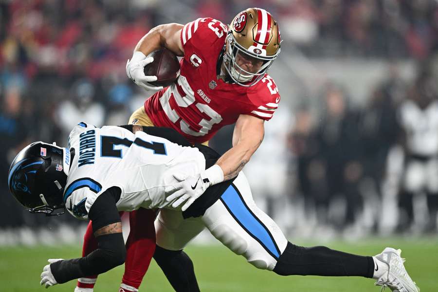 Panthers safety Tre'Von Moehrig stiff-armed by 49ers RB Christian McCaffrey