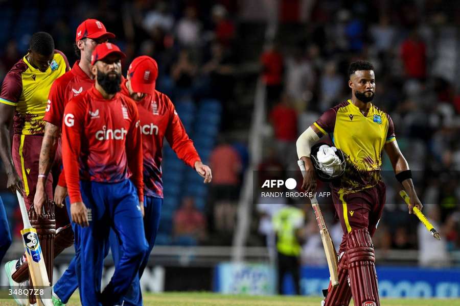 Shai Hope (R) of the West Indies walks off the field after winning the 5th T20I between the West Indies and England