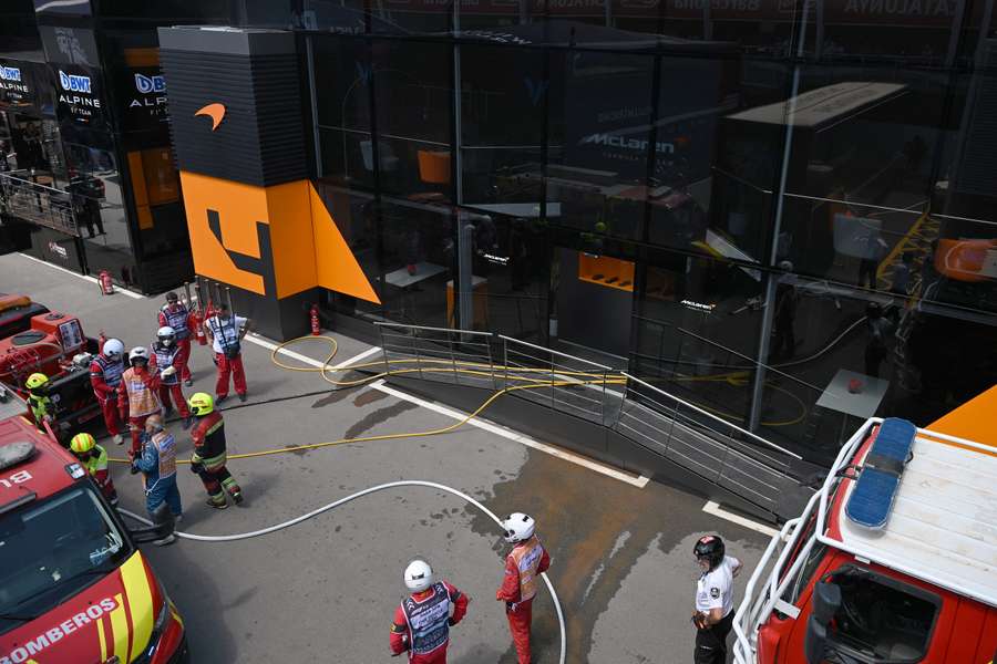 Firefighters work to extinguish a fire at McLaren motor-home at the Circuit de Catalunya 