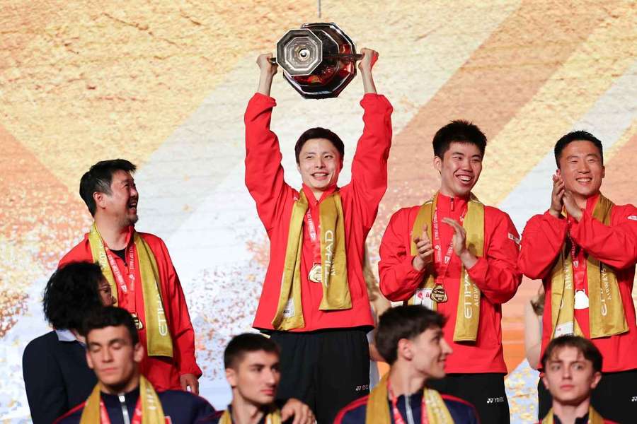 Gold medalist team China's Shi Yuqi (Top, 2nd L) reacts during the awarding ceremony for the Thomas Cup Finals
