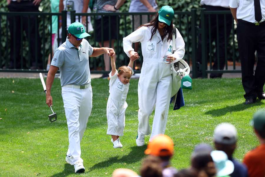 Rickie Fowler of the United States and his wife, Allison Stokke, hold their daughter, Maya