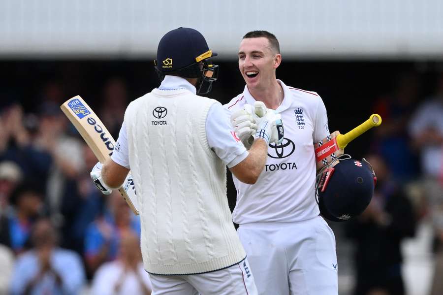 Harry Brook celebrates scoring his century with Joe Root