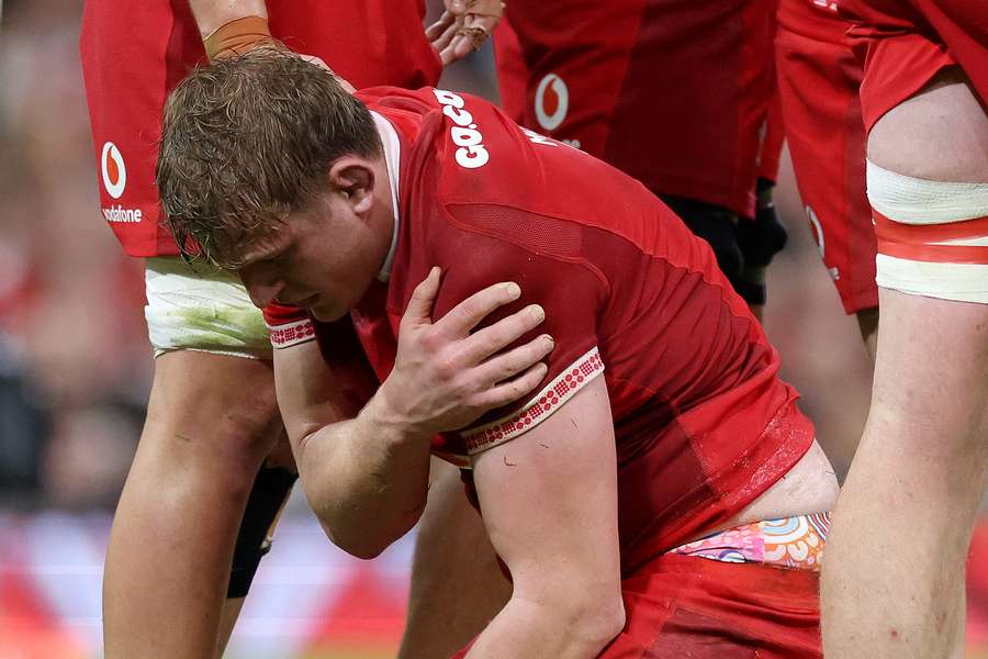 Jac Morgan looks dejected as he holds his shoulder after picking up an injury whilst scoring his team's third try against Argentina