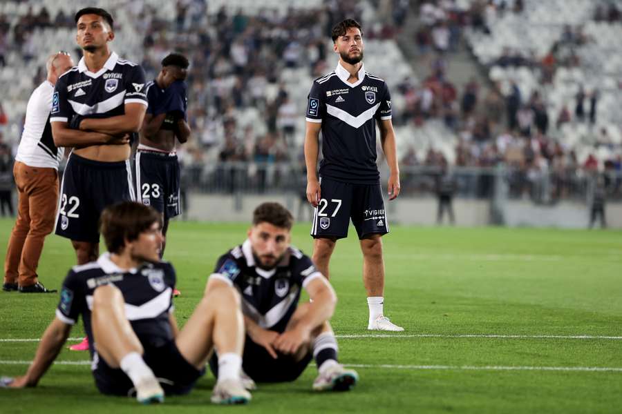 Bordeaux's players react after the French L2 football match between FC Girondins de Bordeaux and Rodez was abandoned by the referee