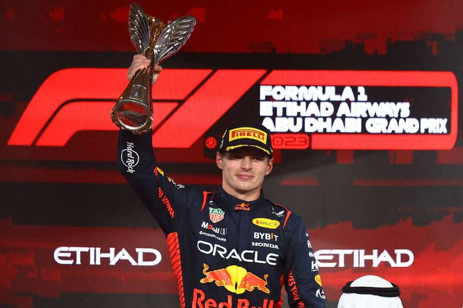 Verstappen celebrates with the trophy on the podium after winning the race