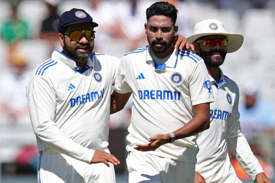 Mohammed Siraj is congratulated by Rohit Sharma after taking one of his six wickets