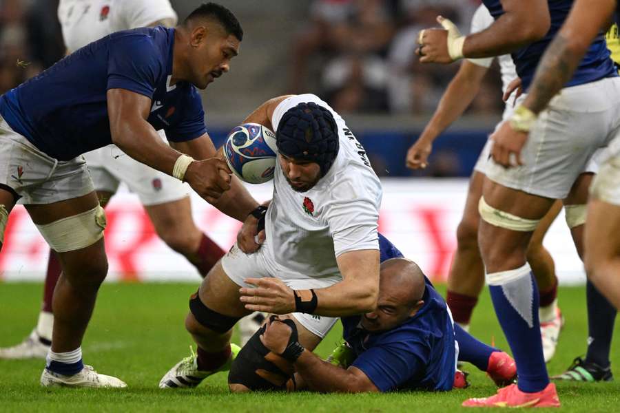 England's lock George Martin is tackled by Samoa's prop James Lay