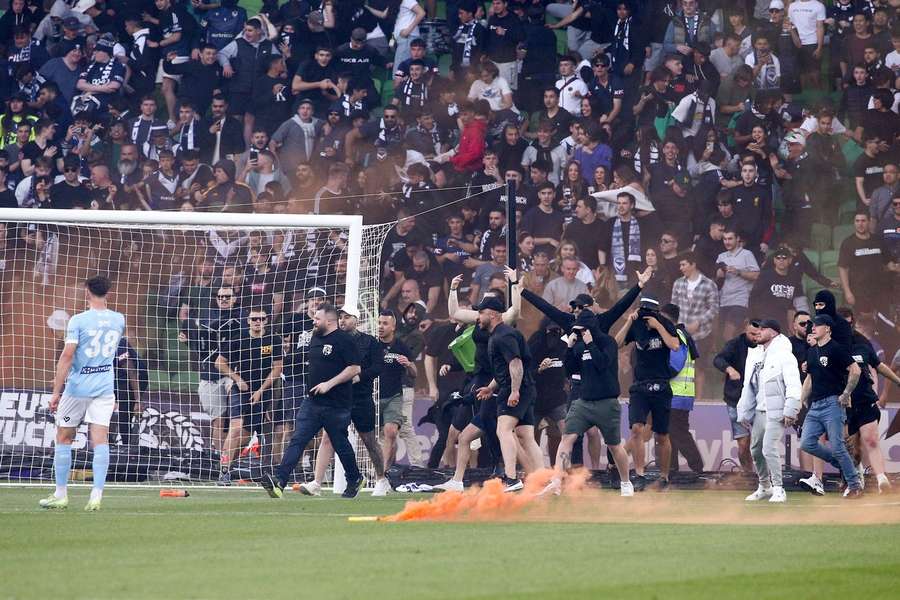A-League's Melbourne derby abandoned after chaotic pitch invasion