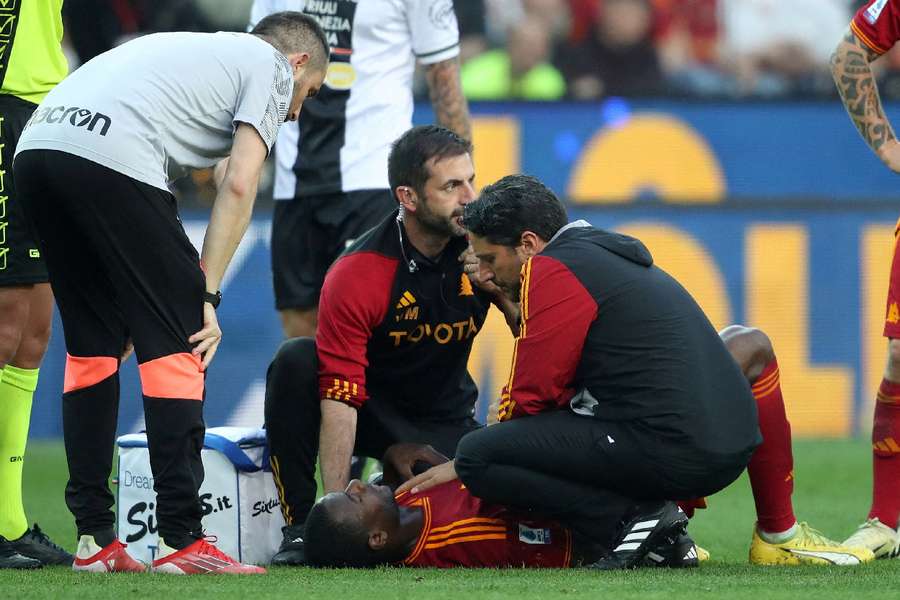 Roma's Evan Ndicka receives medical attention after collapsing on the pitch