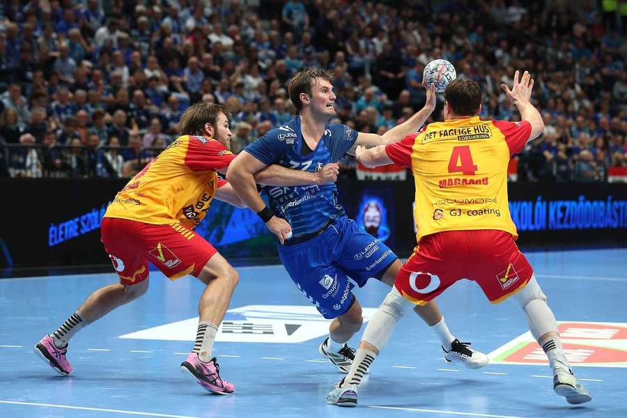 Szeged's Magnus Rod in action against GOG's Steven Plucnar Jacobsen (L) and Andreas Magaard 