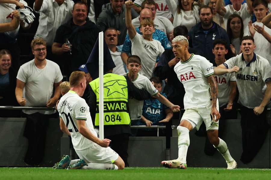 Brazilian striker Richarlison (R) celebrates after scoring his team first goal during the UEFA Champions League match between Tottenham and Marseille