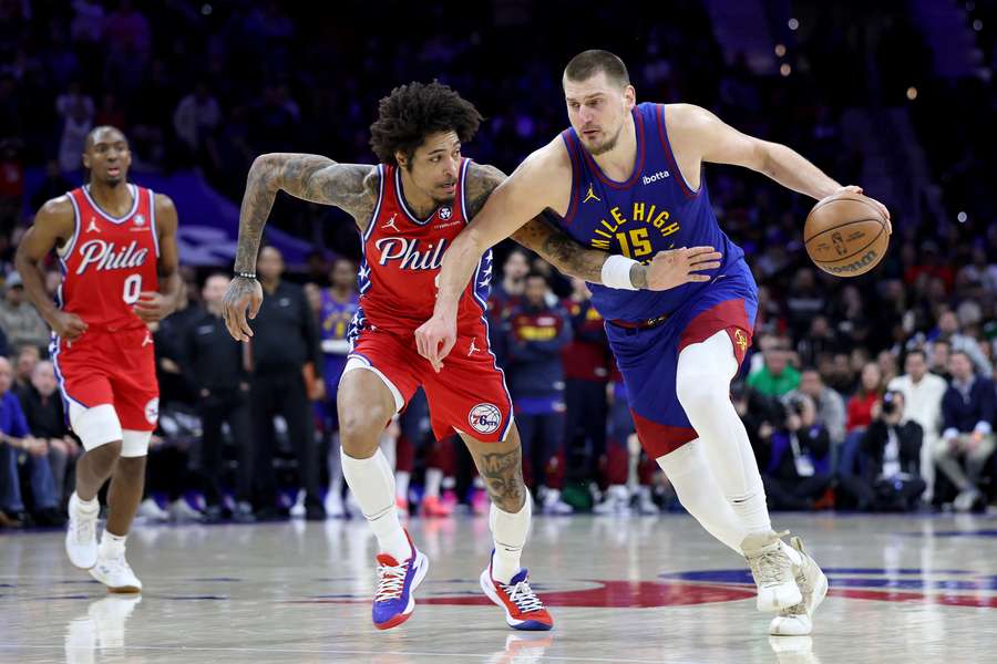 Nikola Jokic driving to the basket before a clutch shot with  Kelly Oubre Jr. defending him