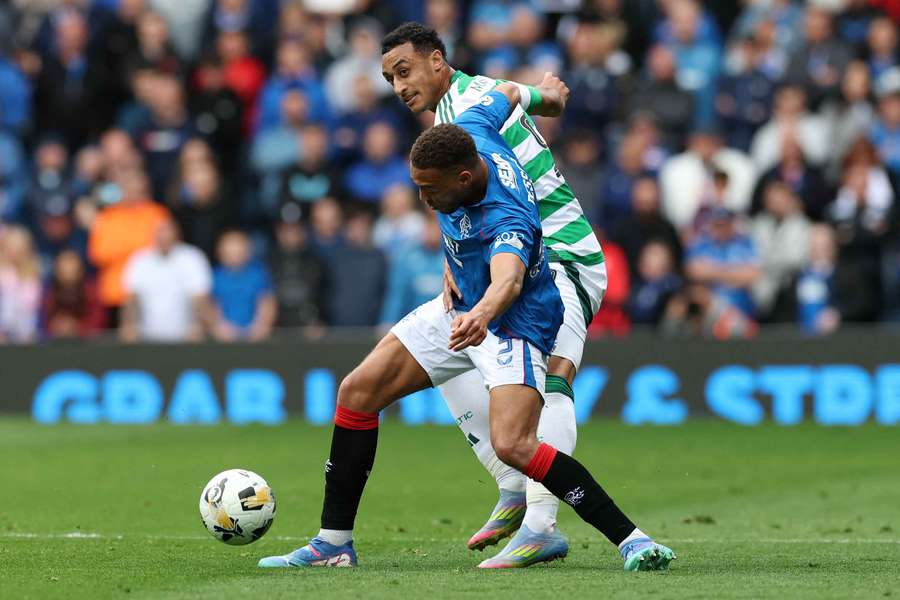 Cyriel Dessers of Rangers controls the ball whilst under pressure from Adam Idah of Celtic