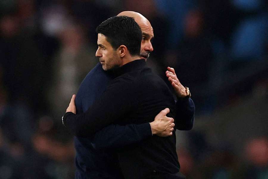 Manchester City manager Pep Guardiola embraces Arsenal manager Mikel Arteta after winning the Carabao Cup