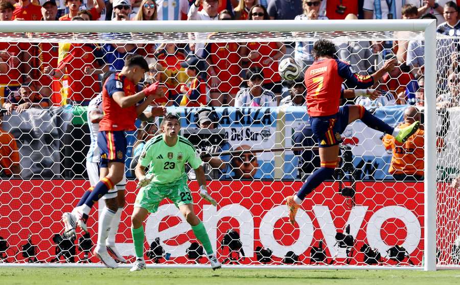 Argentina's Emiliano Martinez in action as Spain's Ferran Torres heads at goal Argentina's Emiliano Martinez in action as Spain's Ferran Torres heads at goal