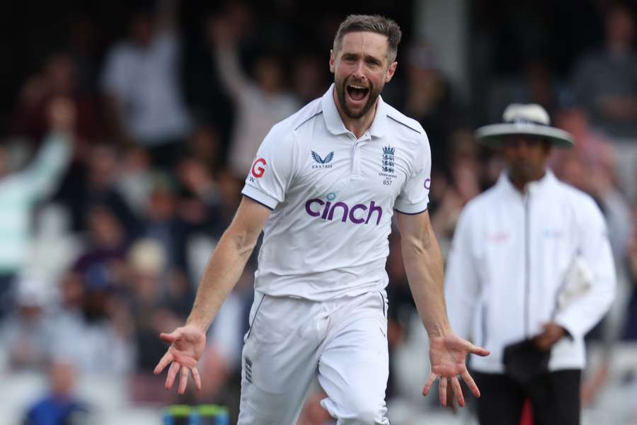 Chris Woakes celebrates after taking the wicket of Australia's Steven Smith on day five of the fifth Ashes Test
