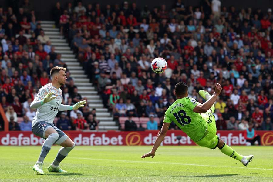 Manchester United's Brazilian midfielder Casemiro (R) scores the opening goal past Bournemouth's Brazilian goalkeeper Neto during the English Premier League football match between Bournemouth and Manchester United