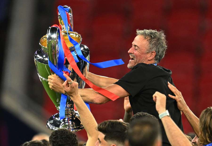 Luis Enrique celebrates with the trophy after winning the UEFA Champions League Luis Enrique celebrates with the trophy after winning the UEFA Champions League